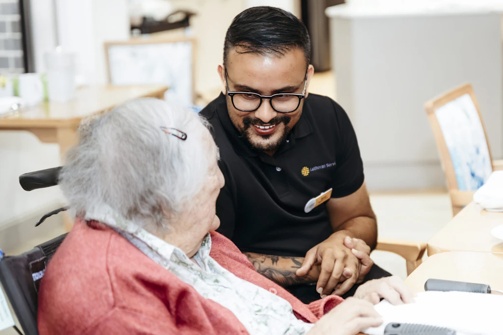 Registered nurse Samir Dhodari talking to an aged care resident.