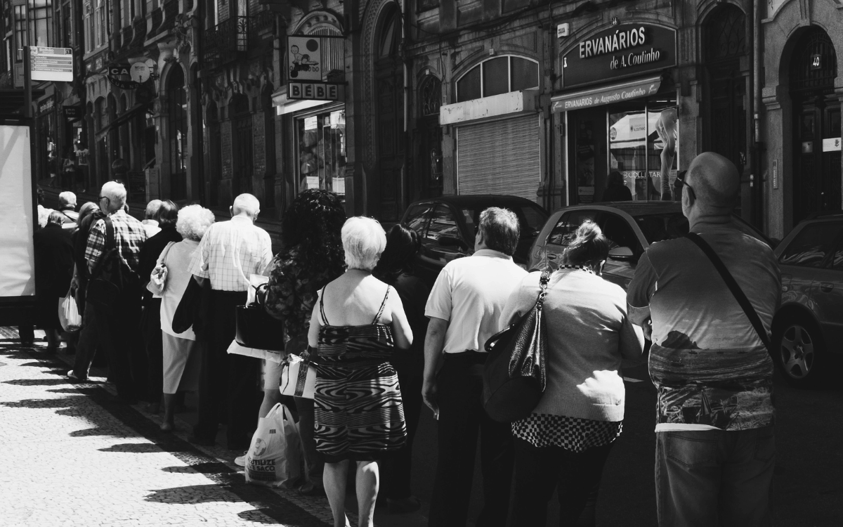 Black and white photo of people lining up